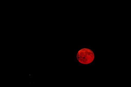 Rising full moon in the evening sky over Limburg