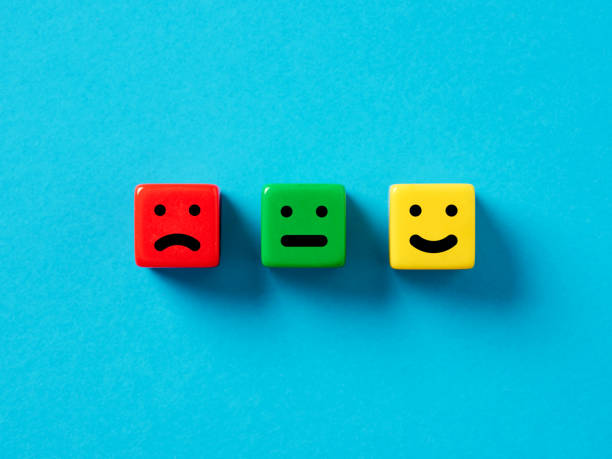 istock Customer satisfaction, user rating and service evaluation concept. Happy sad and neutral emoticon faces on colorful cubes. 1496077495