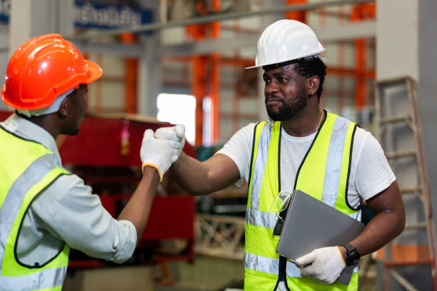 istock Male worker african american teamwork engineer successful handshake at industrial. 1496077549