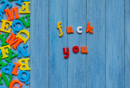 Colorful Fuck You word on wooden