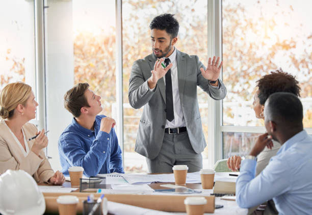 istock Presentation, blueprint and architecture with people in meeting for planning, engineering and designer. Training, teamwork and development with group of employee in office for ideas and proposal 1496078381