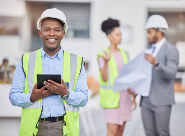 istock Engineer portrait, tablet and smile of black man at construction site for development in city. Architecture, technology and male architect with touchscreen for maintenance, inspection or research. 1496078384