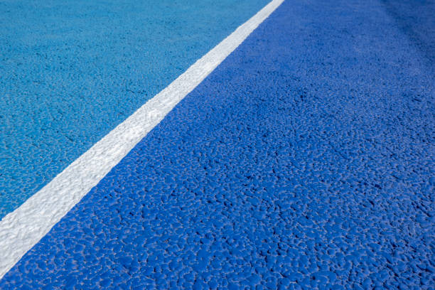 Sport field court background. Blue rubberized and granulated ground surface with white lines on ground. Top view Sport field court background. Blue rubberized and granulated ground surface with white lines on ground. Top view, copy space rubberized stock pictures, royalty-free photos & images