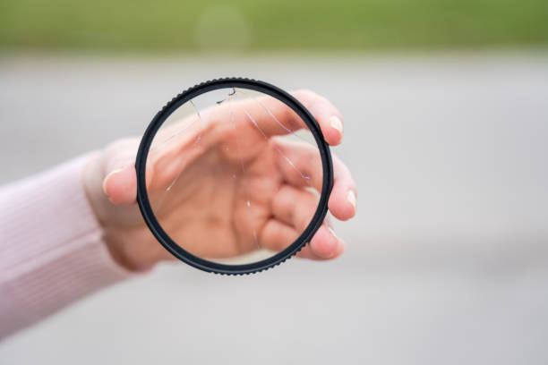 istock DSLR camera with broken protective glass for lens. Cracked photo-filter 1496081163