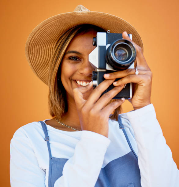 istock Portrait, photographer and black woman with camera, smile and creative against studio background. Face, African American female artist or lady with device, happiness or freelancer with casual clothes 1496081663