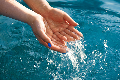 Water surface and hands