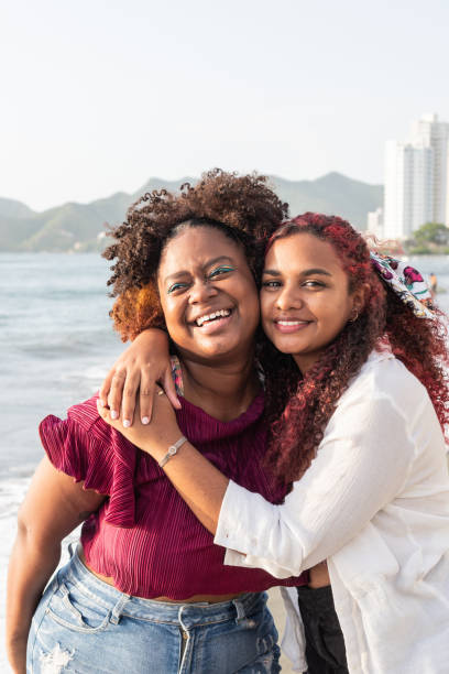 istock happy young friends smiling and hugging 1496085336