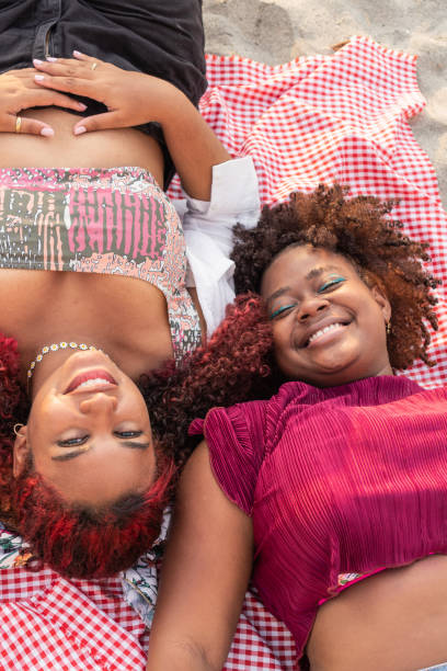 istock Young afro friends laughing and looking at the camera 1496085752