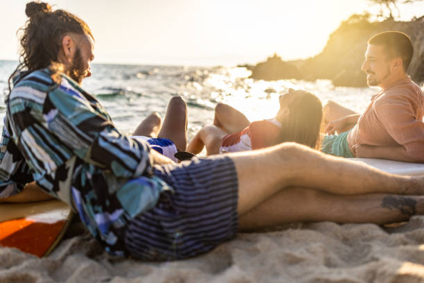 istock Surfers relaxing at the beach 1496087569