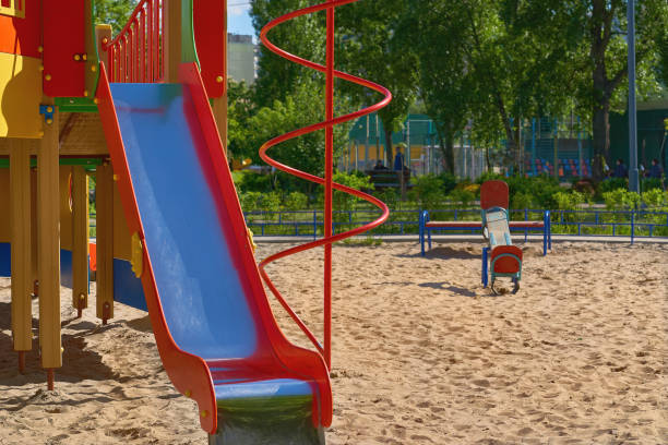 istock Summer spring children's playground with painted toy slide in park 1496087724