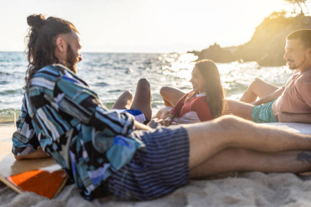 istock Surfers relaxing at the beach 1496087740