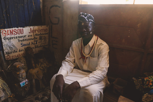 Lome, Togo - April 04, 2023:  Voodoo Priest offering the ritual services in the West Africa