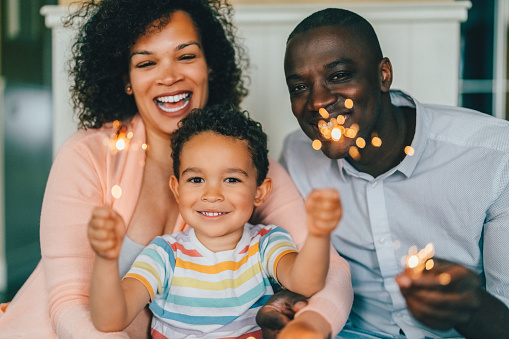 Family at home celebrating a special occasion with sparklers