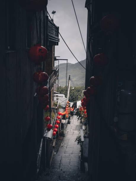 istock a narrow street with some red lanterns strung from the sides 1496092839