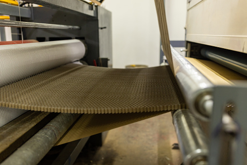 Paper processing machines in a cardboard factory with no people