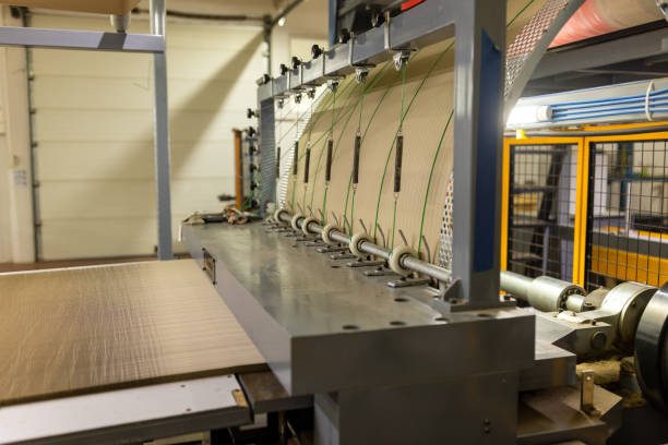 istock Paper processing machinery in a cardboard factory 1496093681