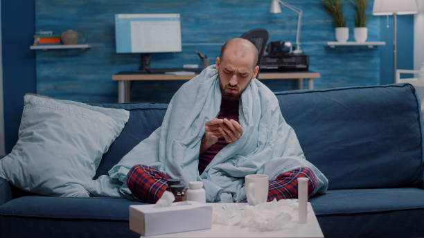 istock POV of ill man using video call communication to cure flu 1496095816