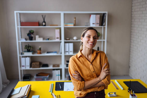 istock A Happy Beautiful Blonde Businesswoman Looking At Camera While Being At Work 1496098117