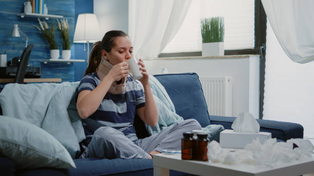 istock Adult with cold and flu wearing cervical neck collar 1496098687