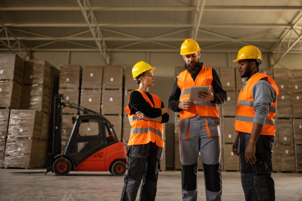 istock Factory employees working in a warehouse 1496099975