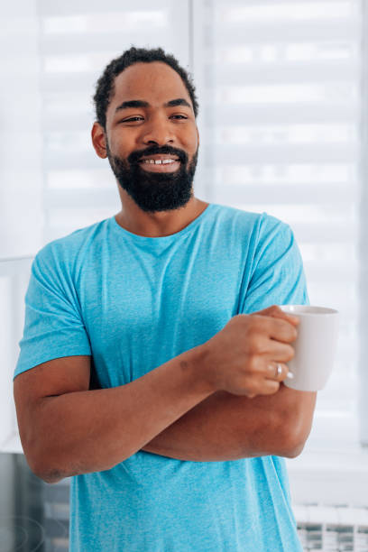 istock Man holding a cup of coffee 1496100426