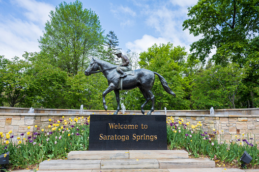 Saratoga Springs, USA - May 21, 2023. Welcome to Saratoga Springs with horse race statue in Saratoga Springs, New York, USA