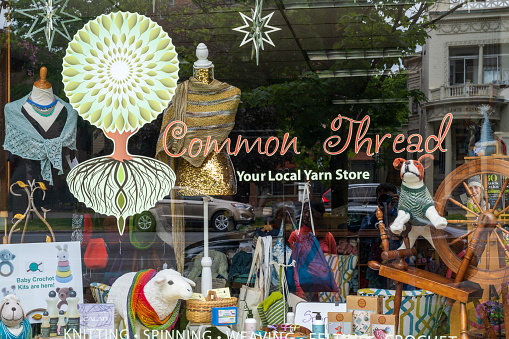 Saratoga Springs, USA - May 21, 2023. Window display of Common Thread yarn store in downtown Saratoga Springs, New York, USA