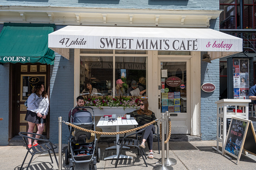 Saratoga Springs, USA - May 21, 2023. People dining at Sweet Mimi's Cafe in downtown Saratoga Springs, New York, USA