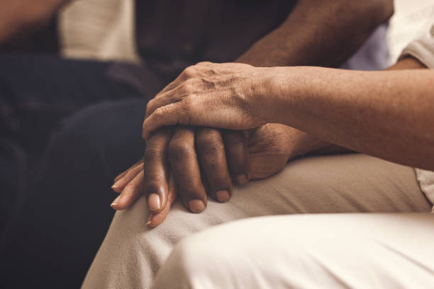 Lend a hand when you can A multiracial couple comforting each other. woman comforting depressed friend stock pictures, royalty-free photos & images