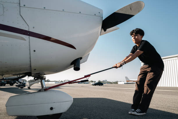 istock A young student pilot is learning how to use a tow bar to move an aircraft 1496102209