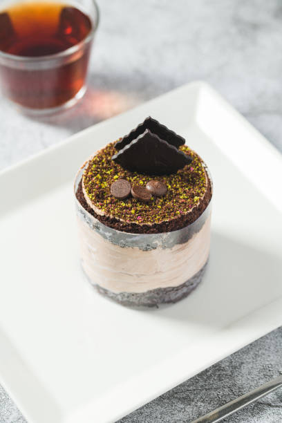 istock Chocolate single mini cake on a white porcelain plate 1496103867