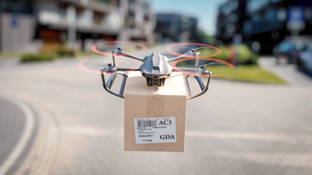 A delivery drone is flying between residential buildings - the concept of delivering packages using an unmanned drone A delivery drone is flying between residential buildings - the concept of delivering packages using an unmanned drone automated photos stock pictures, royalty-free photos & images