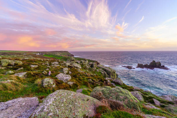 Sunset view of the Lands End coastline landscape, in Cornwall, England, UK