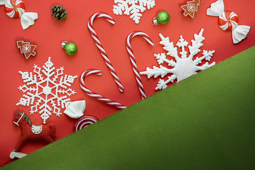 3d render, Christmas flat lay over green background. White porcelain plate filled with festive treats, gingerbread cookies, candy cane. Holiday food