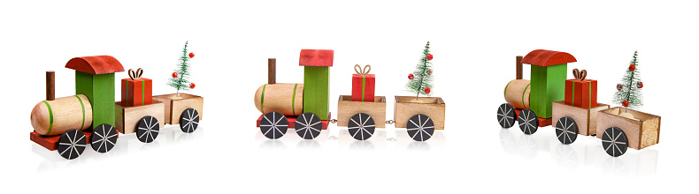 Christmas Toy Train Isolated on White Carrying a Gift Box and a Christmas Tree