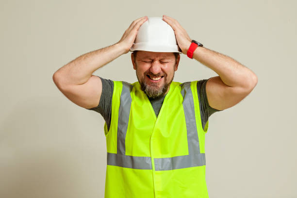 istock worker in a vest and white helmet 1496111243