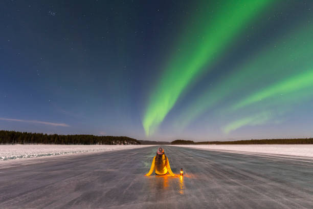 istock Woman with lantern and northern lights 1496111299