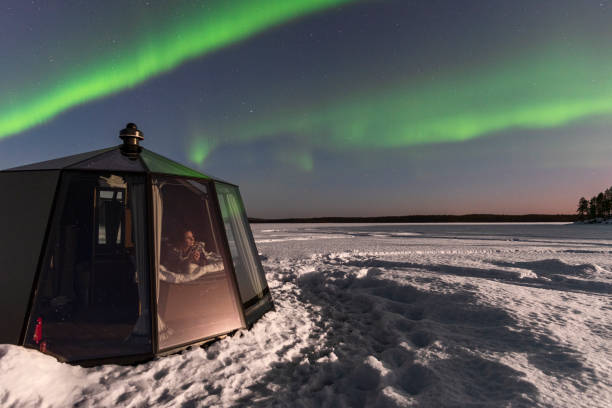 istock Woman adrmiring northern lights 1496111301