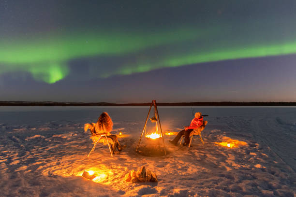 istock People admire northern lights around the fire on the ice 1496111354