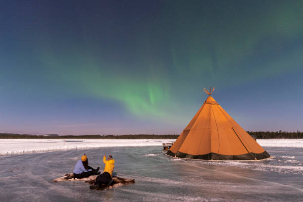 istock Two people and a Sami tent under aurora borealis 1496111360