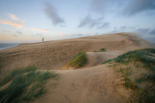 Scenic view of Rubjerg Knude lighthouse in sandstorm in summer