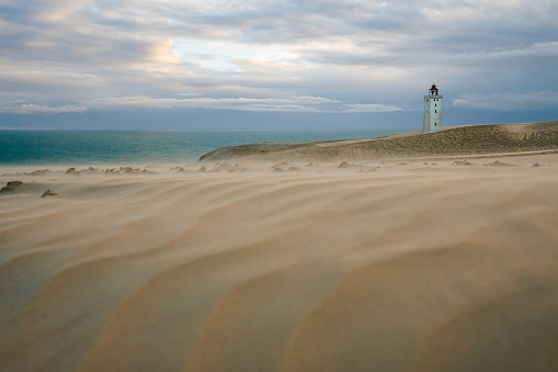 Scenic view of Rubjerg Knude lighthouse in sandstorm in summer