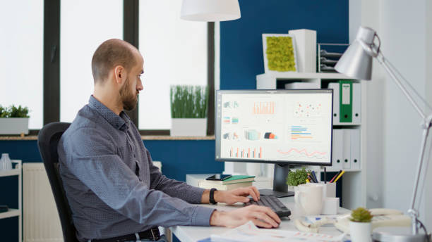 istock Business man doing financial research on computer in startup office 1496114905
