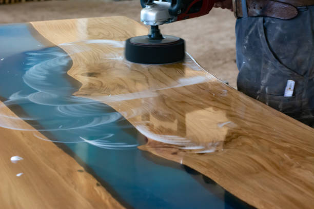 istock Lacquer polishing on an oak and epoxy resin table in a local workshop 1496116358