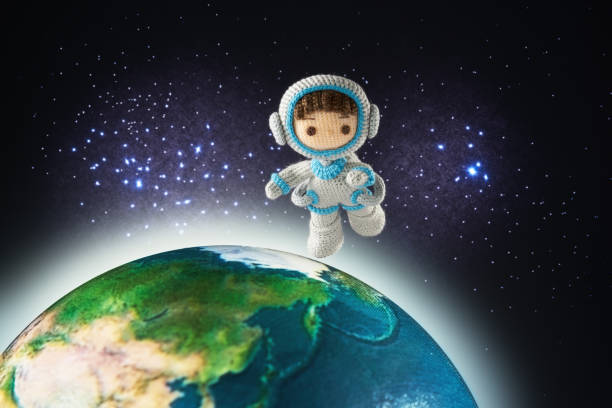 istock Small and cute Amigurumi doll .　astronaut in outer space 1496117453