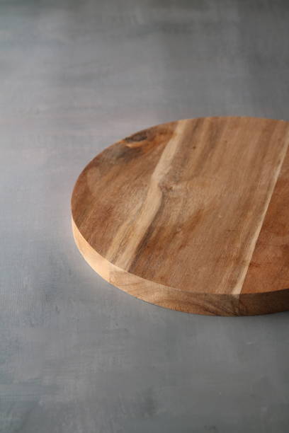 istock photo round wooden board on a light gray background 1496119052