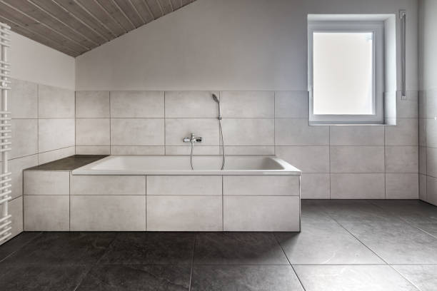 istock Modern european bathroom, with white bath tub and a window 1496119992