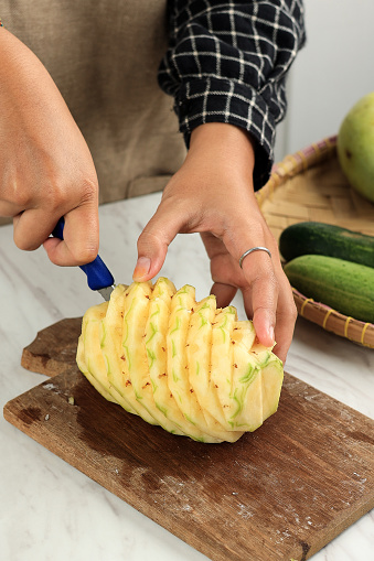 Woman Hand Cut Pineapple in the Kitchen, Process making Tropical Fruit Juice