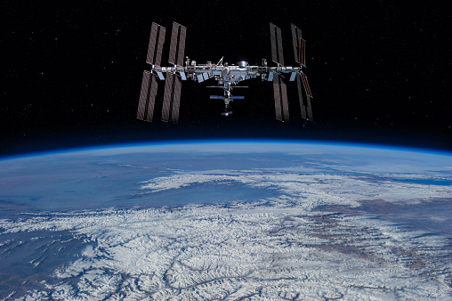 International space station on orbit of the Earth planet. View from outer space.ISS. Earth with clouds and blue sky. Elements of this image furnished by NASA (url: https://images-assets.nasa.gov/image/iss056e201225/iss056e201225~small.jpg https://www.nasa.gov/sites/default/files/styles/full_width_feature/public/thumbnails/image/iss065e333863.jpg)