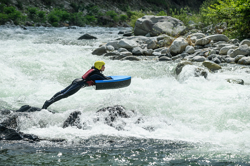 Woman whitewater kayaking on Montana River.